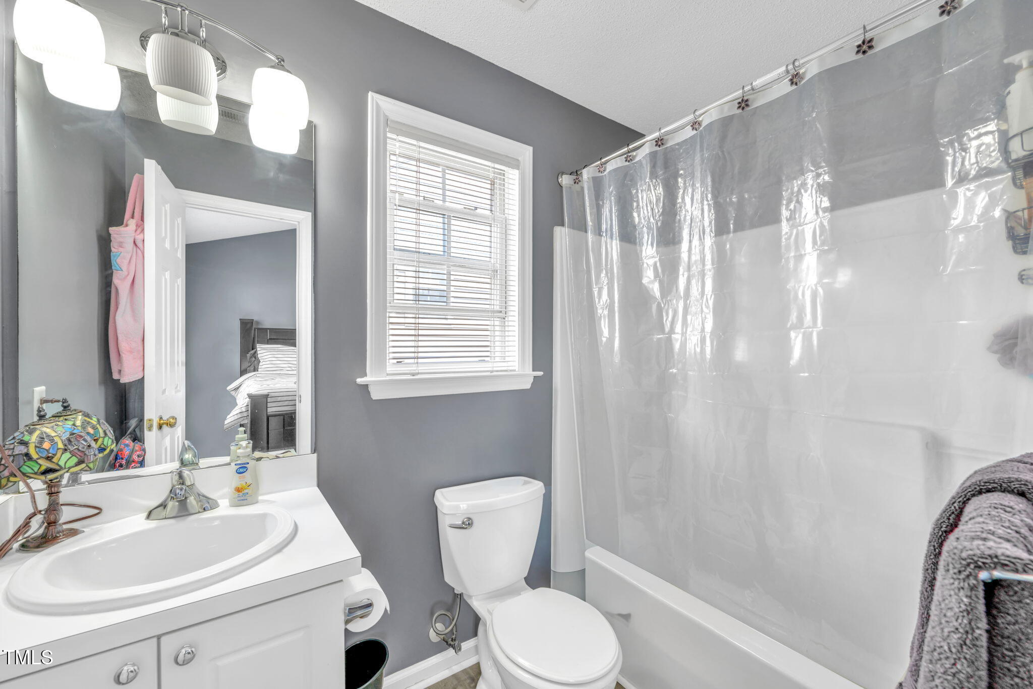 2203 Whistling Straits Way Raleigh, NC 27604 - Photo 14 of 32 a bathroom with a sink toilet and shower