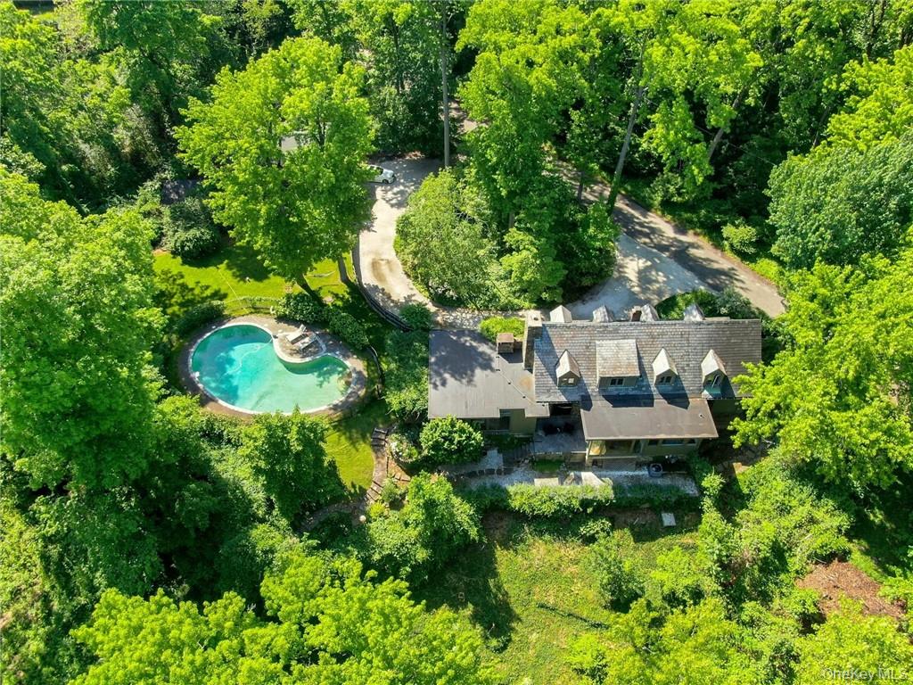 an aerial view of a house with a yard basket ball court and outdoor seating