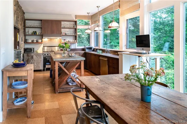 a kitchen with a sink a table and chairs in it