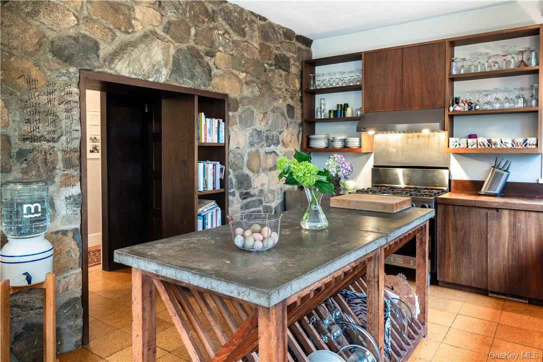 21 Woods Road Palisades, NY 10964 - Photo 15 of 47 a kitchen with a sink a table and chairs in it