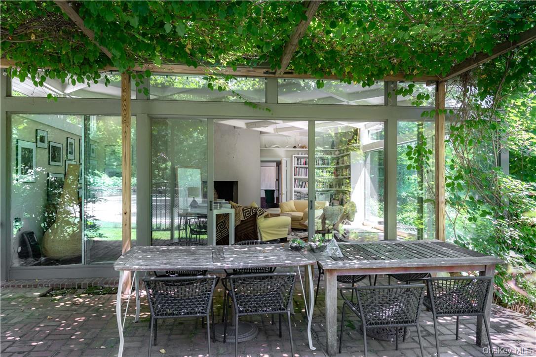 21 Woods Road Palisades, NY 10964 - Photo 16 of 47 a view of a patio with table and chairs potted plants and large tree