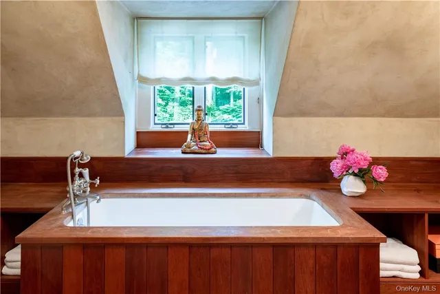 a bathroom with a sink shower and a mirror
