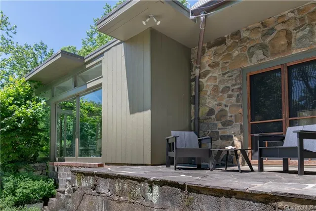 a backyard of a house with lots of green space and fountain