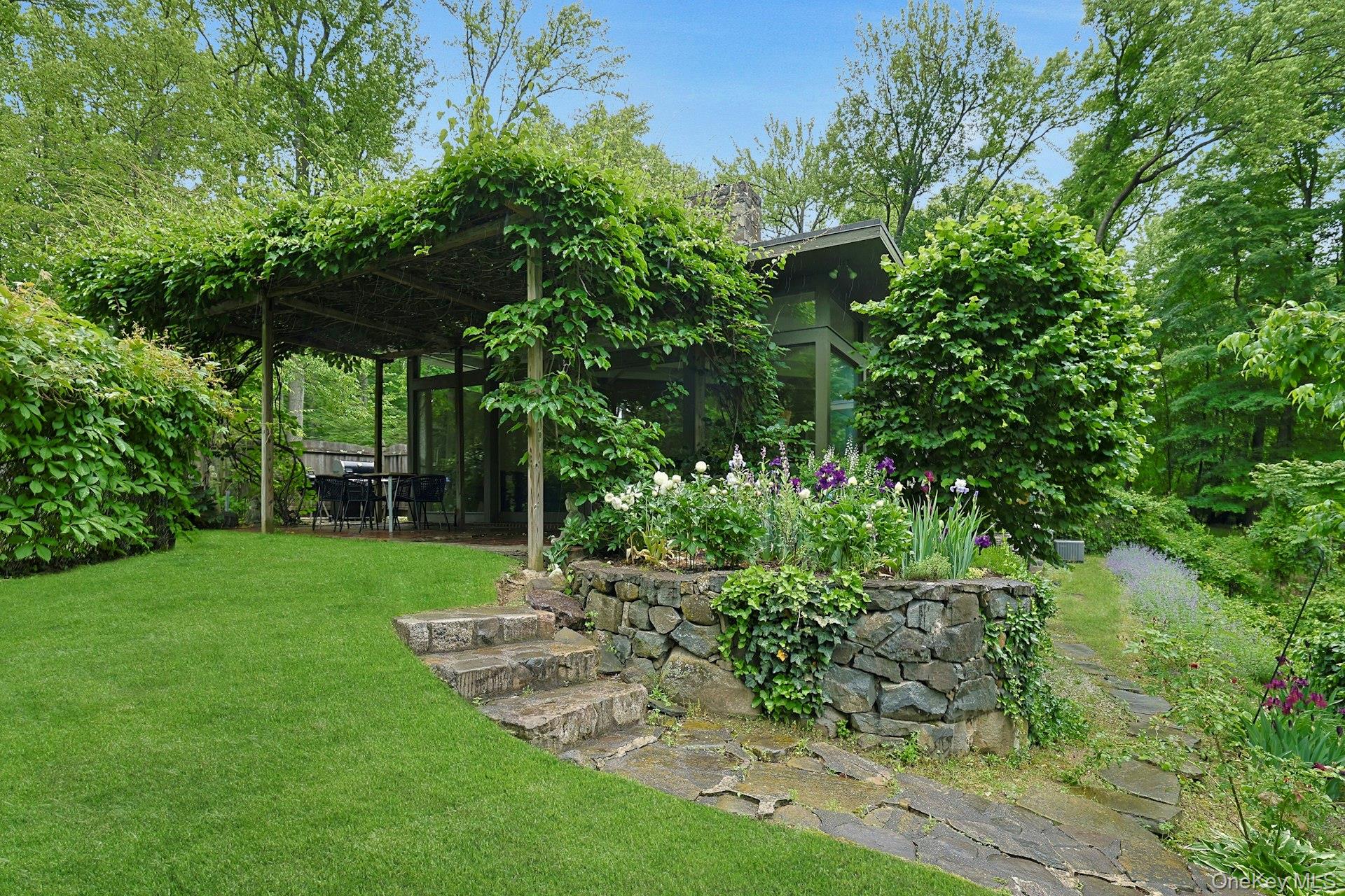 21 Woods Road Palisades, NY 10964 - Photo 35 of 47 a view of a backyard with potted plants and large trees