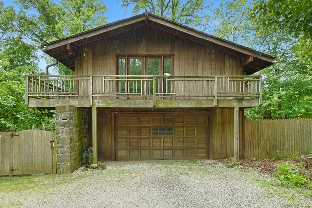 a view of house with backyard and garden