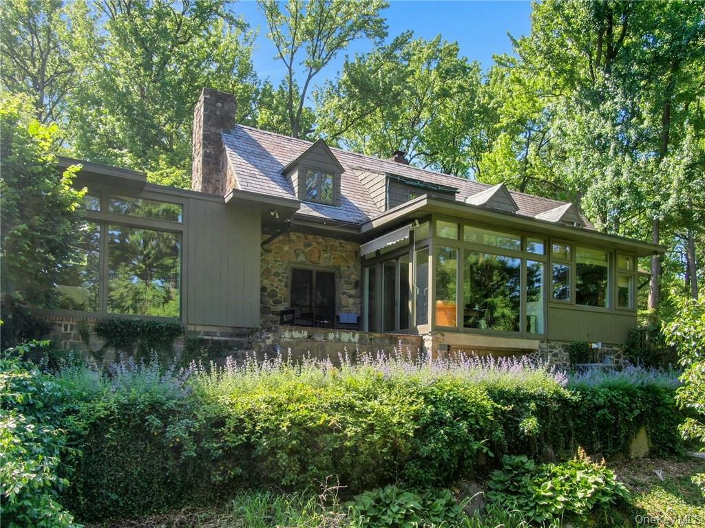 21 Woods Road Palisades, NY 10964 - Photo 7 of 47 a front view of a house with a yard and potted plants