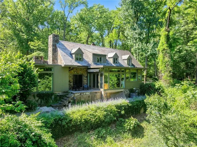 an aerial view of a house with swimming pool and garden