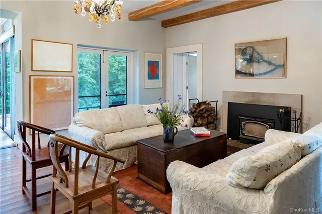 a living room with furniture fireplace and a large window