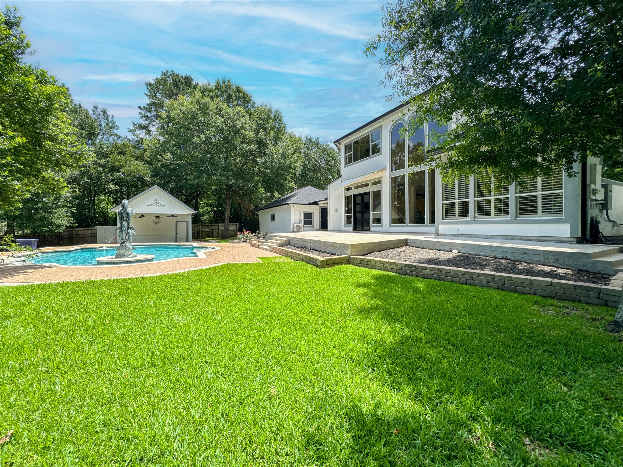 1810 Woerner Road Houston, TX 77090 - Photo 35 of 39 Stunning backyard oasis with a sparkling pool and spacious patio—perfect for relaxation and entertaining.