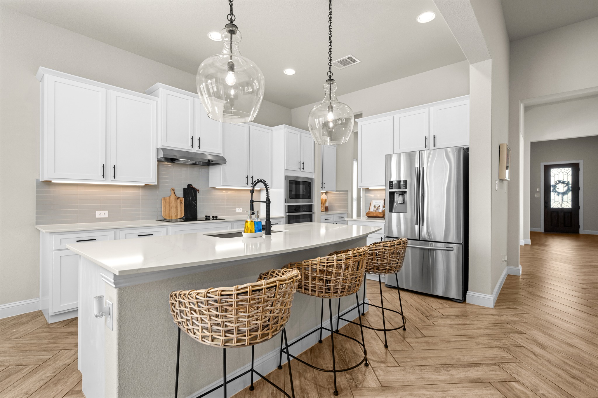 2100 Highland Ridge Road Georgetown, TX 78628 - Photo 11 of 30 A pristine kitchen features ample counter space, bright cabinetry, and a generously sized island with seating.