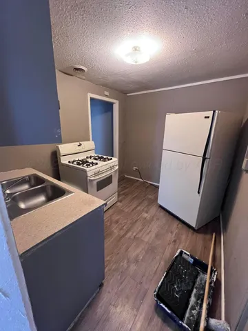 a kitchen with stainless steel appliances granite countertop a stove and a refrigerator