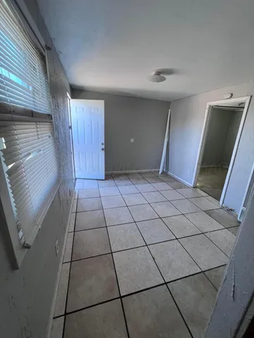 a view of a livingroom with an empty space and a window