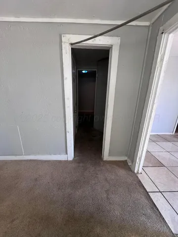 a view of an empty room and a window