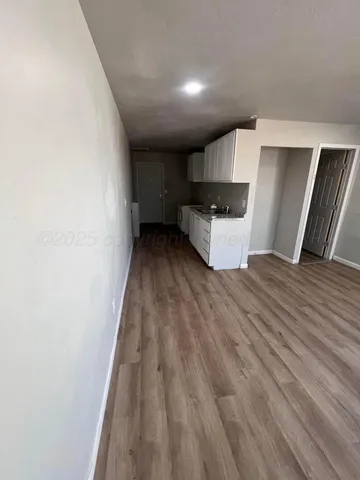 a view of kitchen with cabinets and wooden floor