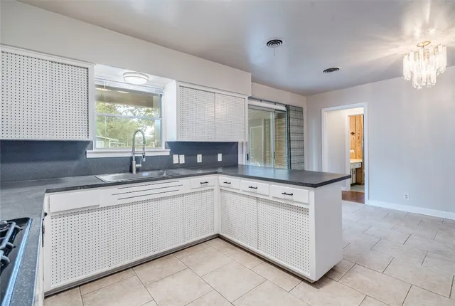 a kitchen with stainless steel appliances granite countertop a sink and cabinets