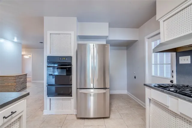 a kitchen with stainless steel appliances granite countertop a refrigerator and a sink