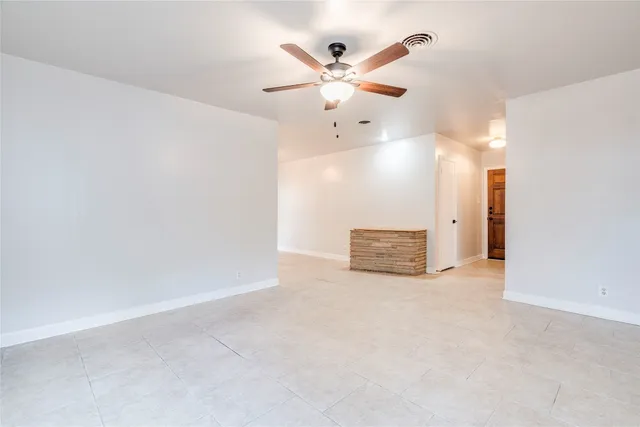 an empty room with fan and a ceiling fan