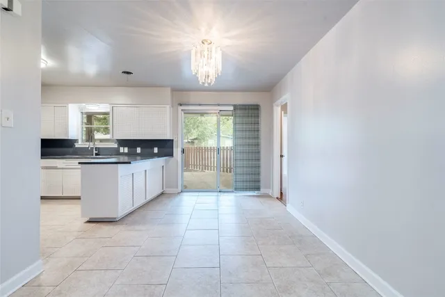 a large kitchen with granite countertop a stove a sink dishwasher and a refrigerator