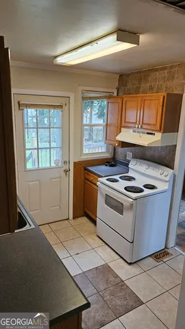 a white stove top oven sitting inside of a kitchen