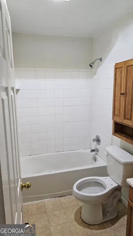 a bathroom with a toilet and a bathtub