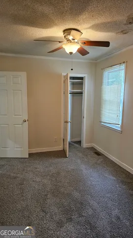 en empty room with windows and closet