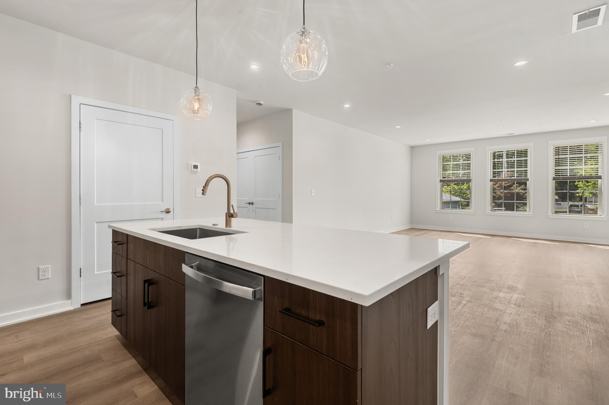 a kitchen with a sink cabinets and window