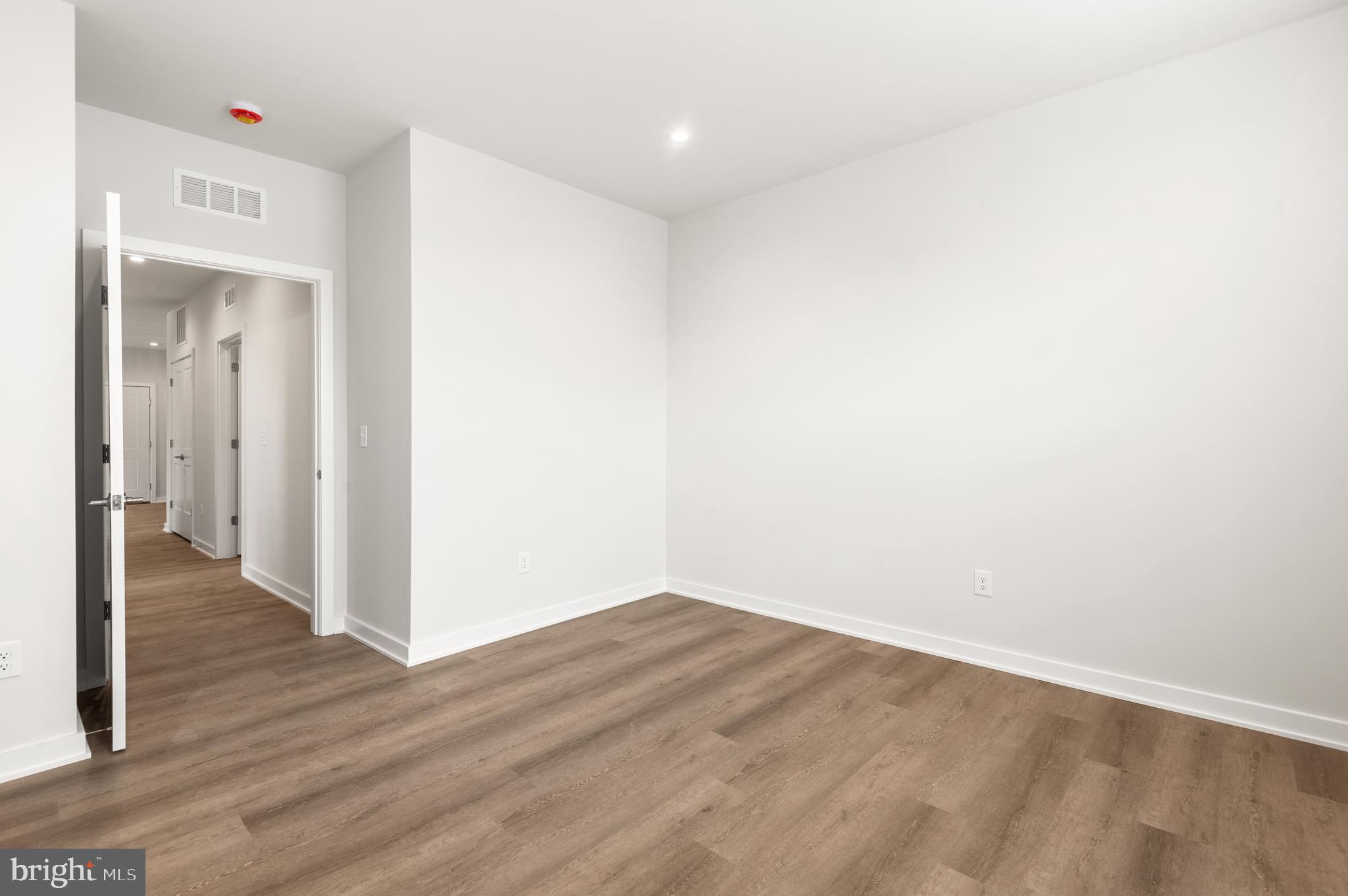 26 South York Road, Unit 201 Hatboro, PA 19040 - Photo 15 of 52 a view of an empty room with wooden floor