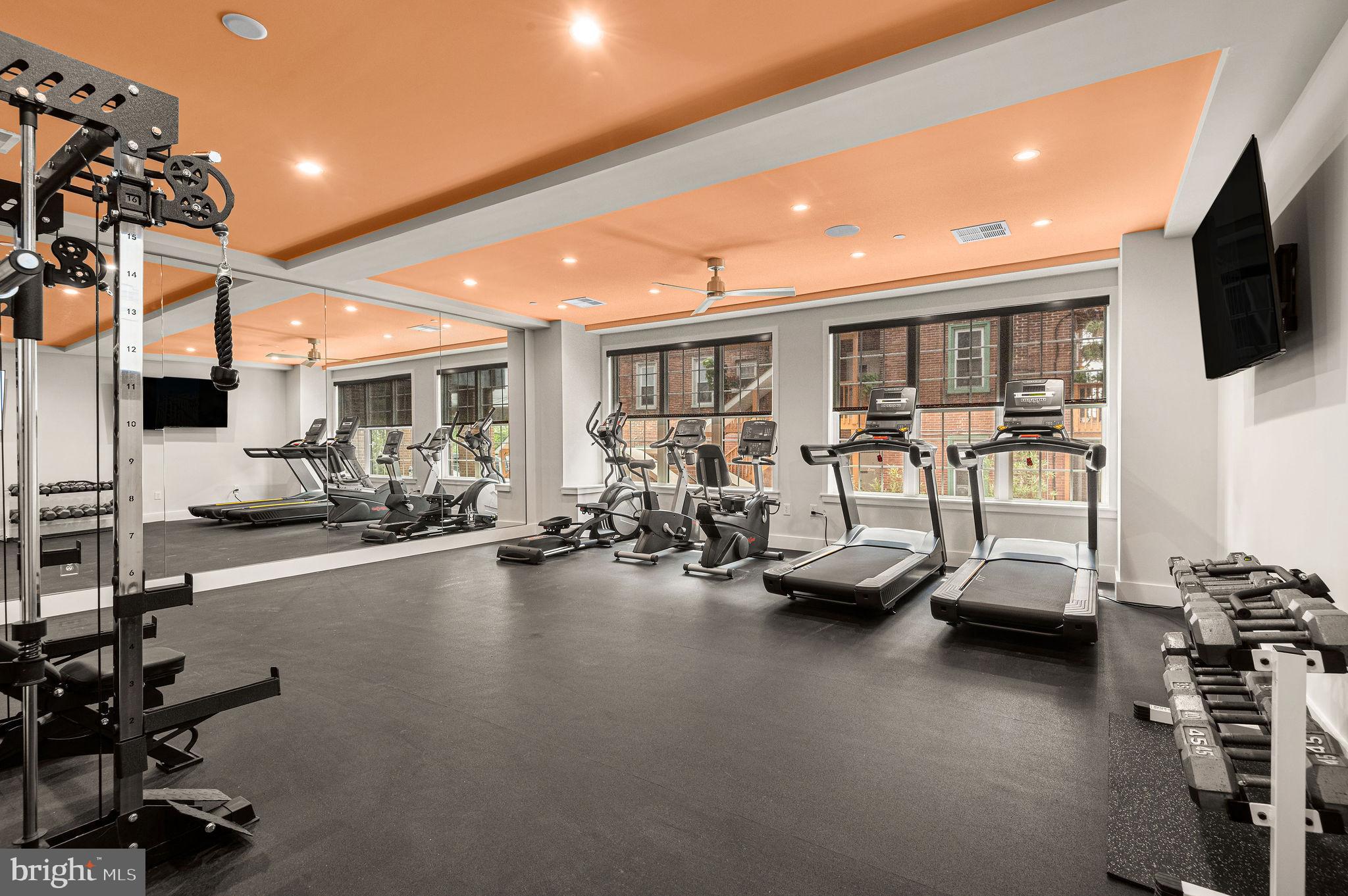 26 South York Road, Unit 201 Hatboro, PA 19040 - Photo 50 of 52 a room with gym equipment and a flat screen tv