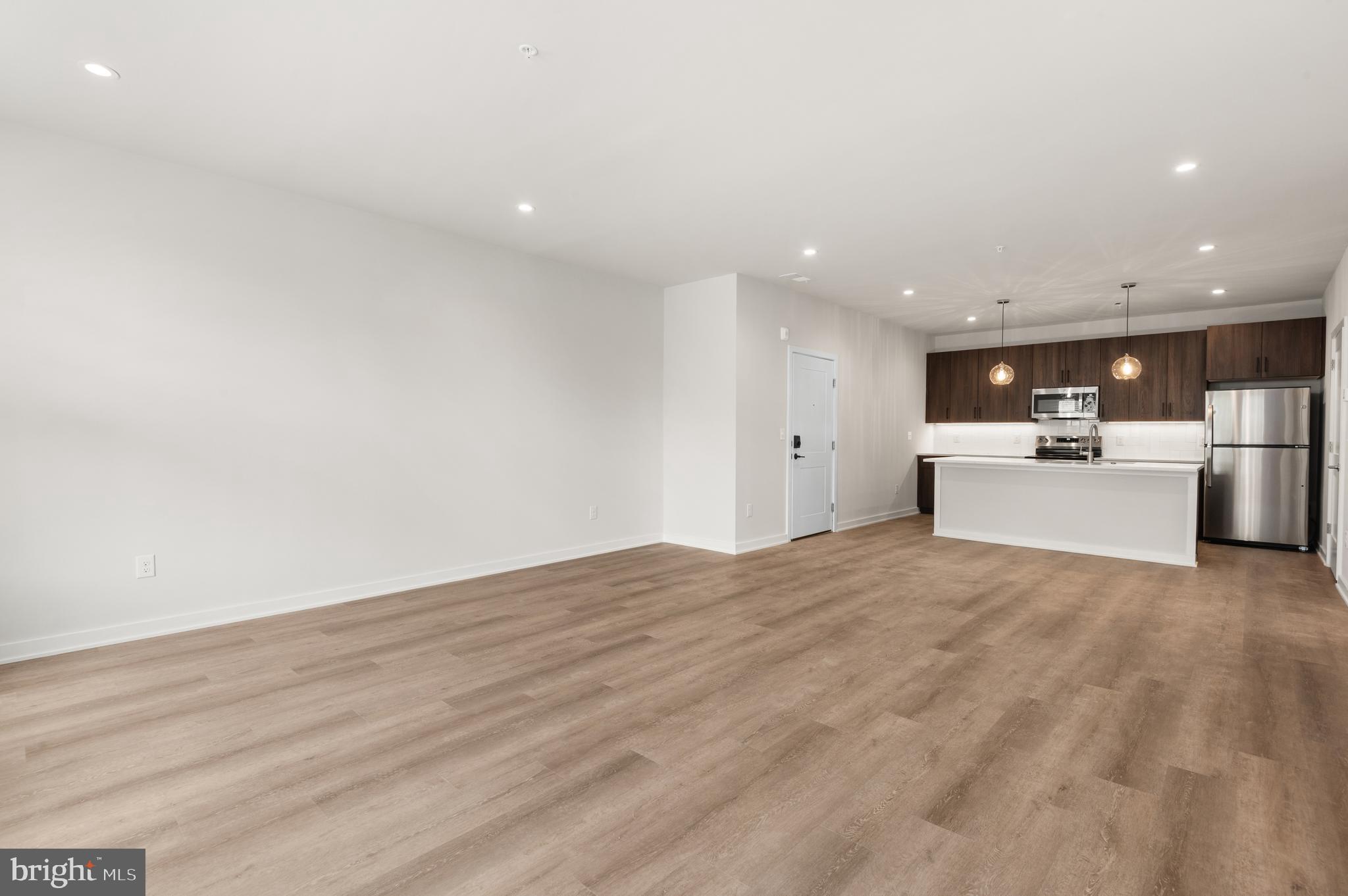 26 South York Road, Unit 201 Hatboro, PA 19040 - Photo 7 of 52 a view of a kitchen with a sink and a refrigerator