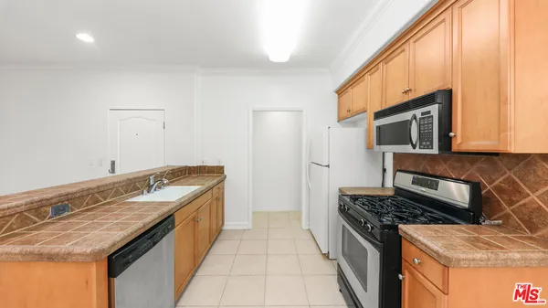 a kitchen with granite countertop a sink and a stove top oven