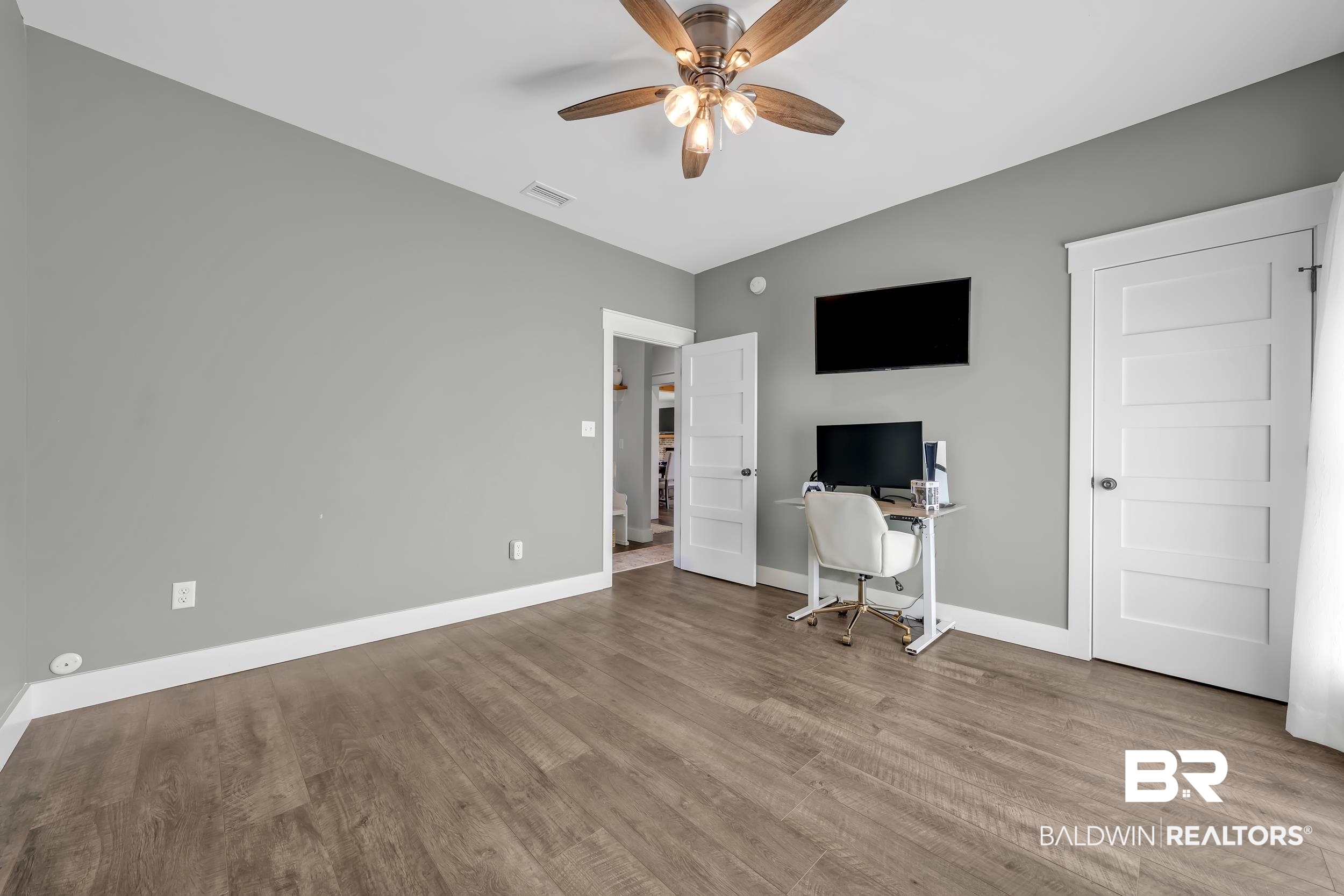 6576 Ranch Loop Road East Grand Bay, AL 36541 - Photo 23 of 39 Spacious room featuring wood-finish flooring, light grey walls, and white trim