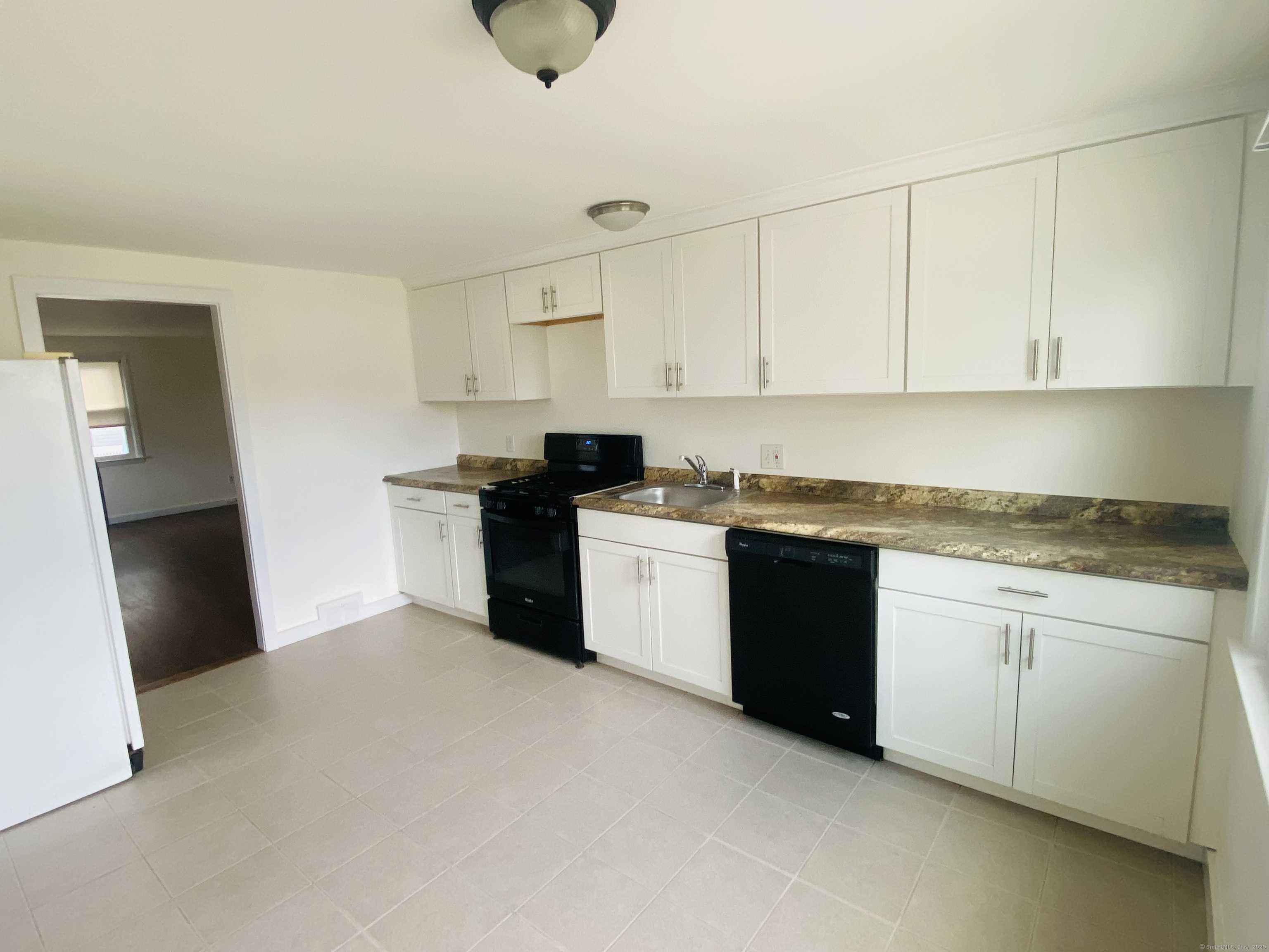 35 Harding Avenue Stratford, CT 06615 - Photo 2 of 10 a kitchen with stainless steel appliances granite countertop a stove a sink and a refrigerator