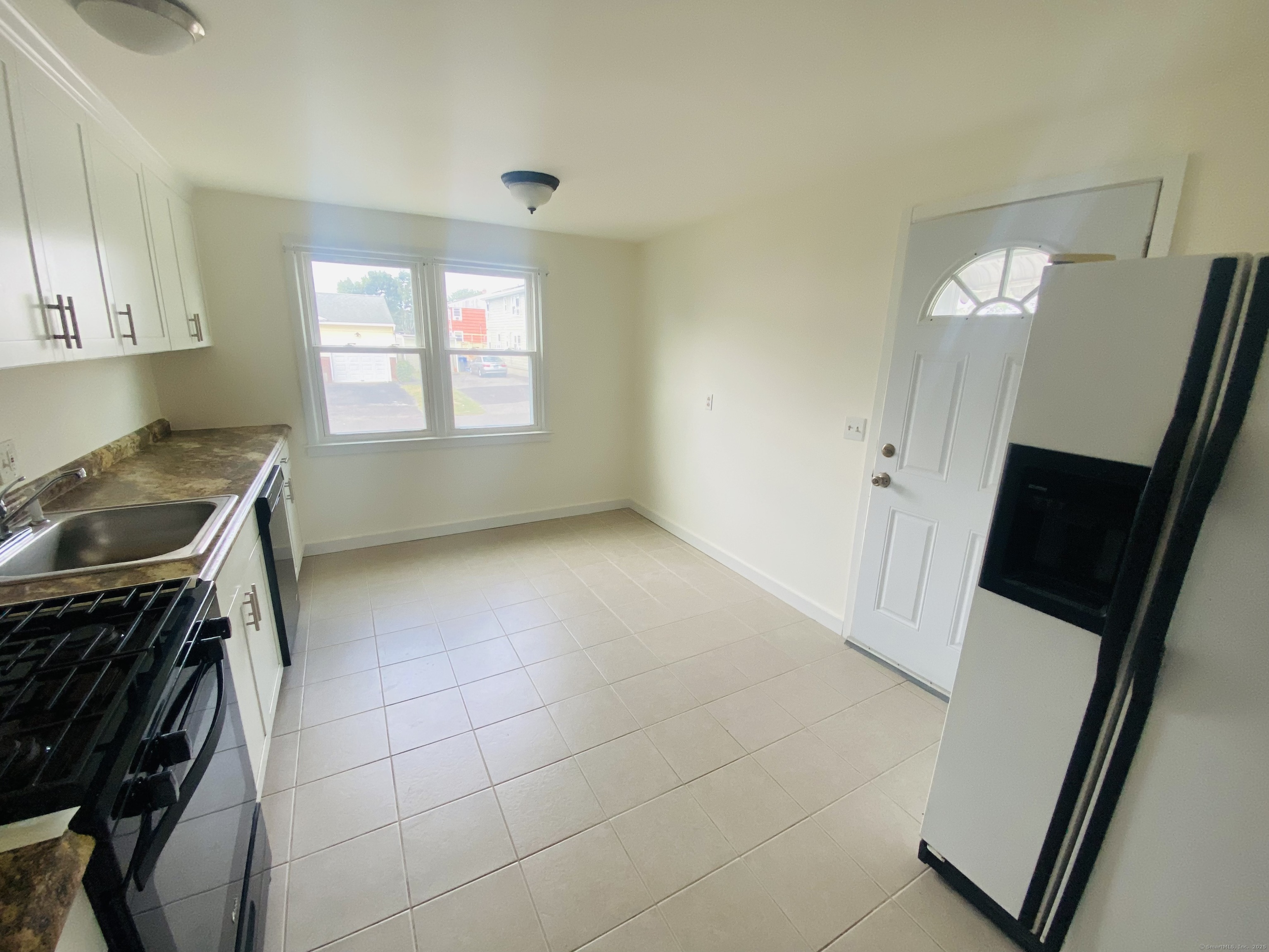 35 Harding Avenue Stratford, CT 06615 - Photo 3 of 10 a kitchen with a sink a stove cabinets and a window