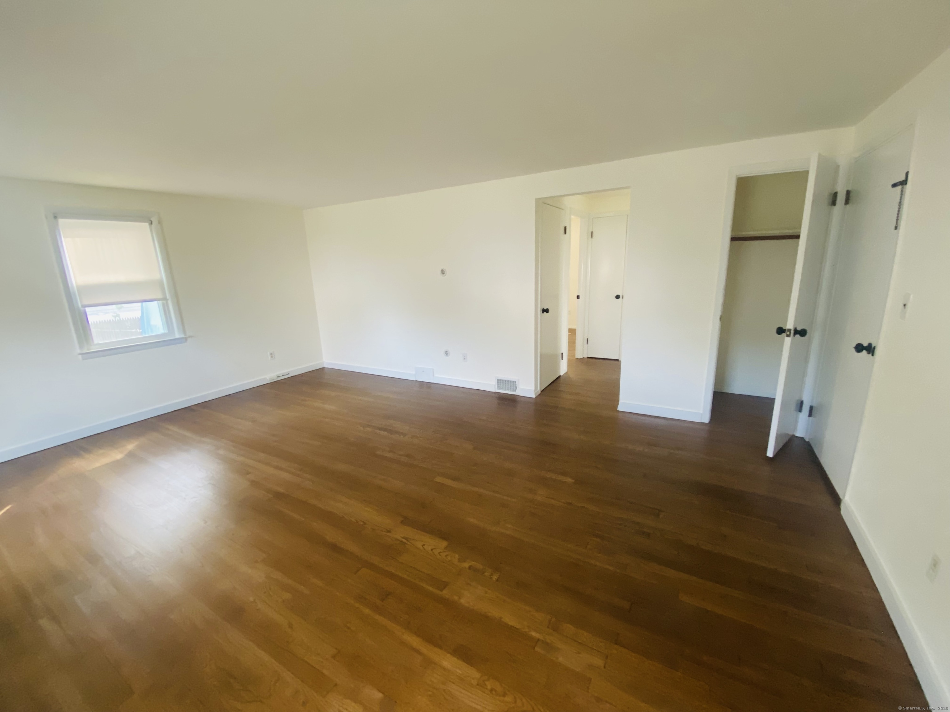 35 Harding Avenue Stratford, CT 06615 - Photo 6 of 10 an empty room with wooden floor and windows