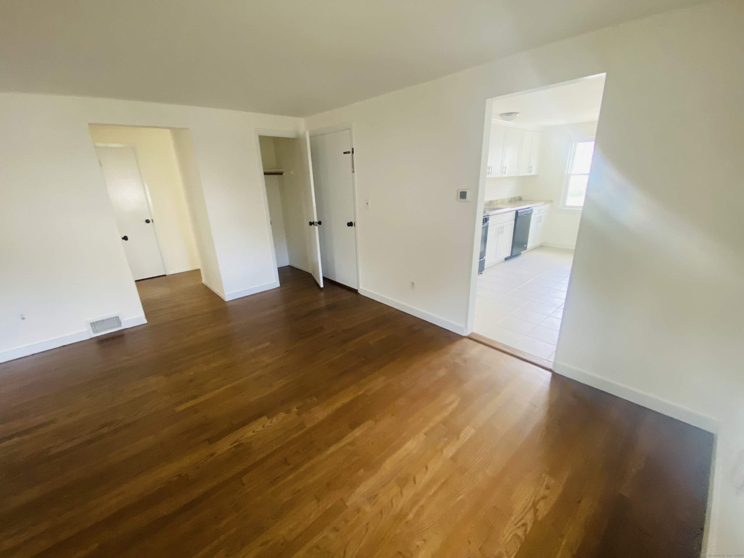 35 Harding Avenue Stratford, CT 06615 - Photo 7 of 10 a view of empty room with wooden floor