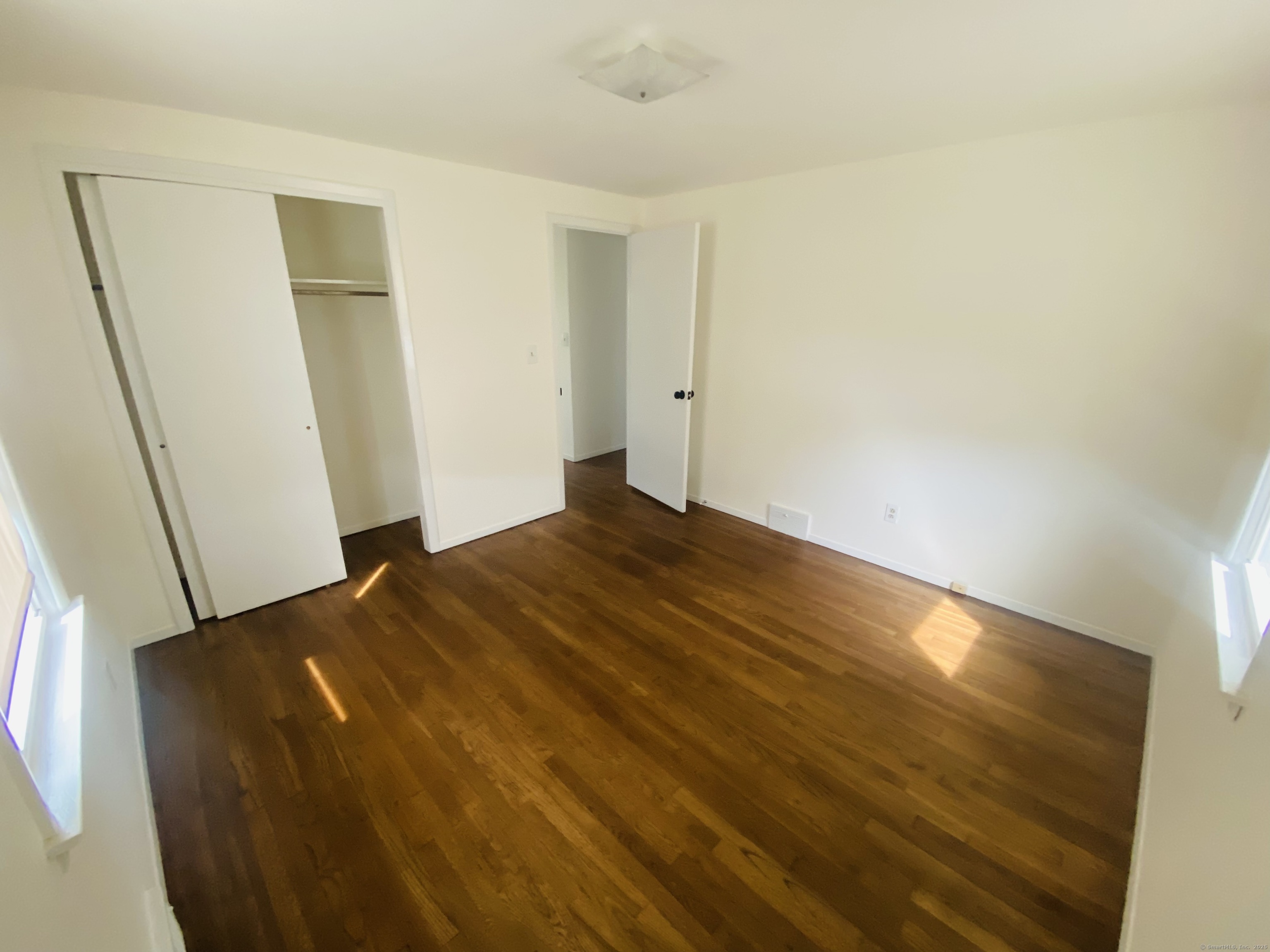 35 Harding Avenue Stratford, CT 06615 - Photo 8 of 10 a bedroom with a bed and wooden floor