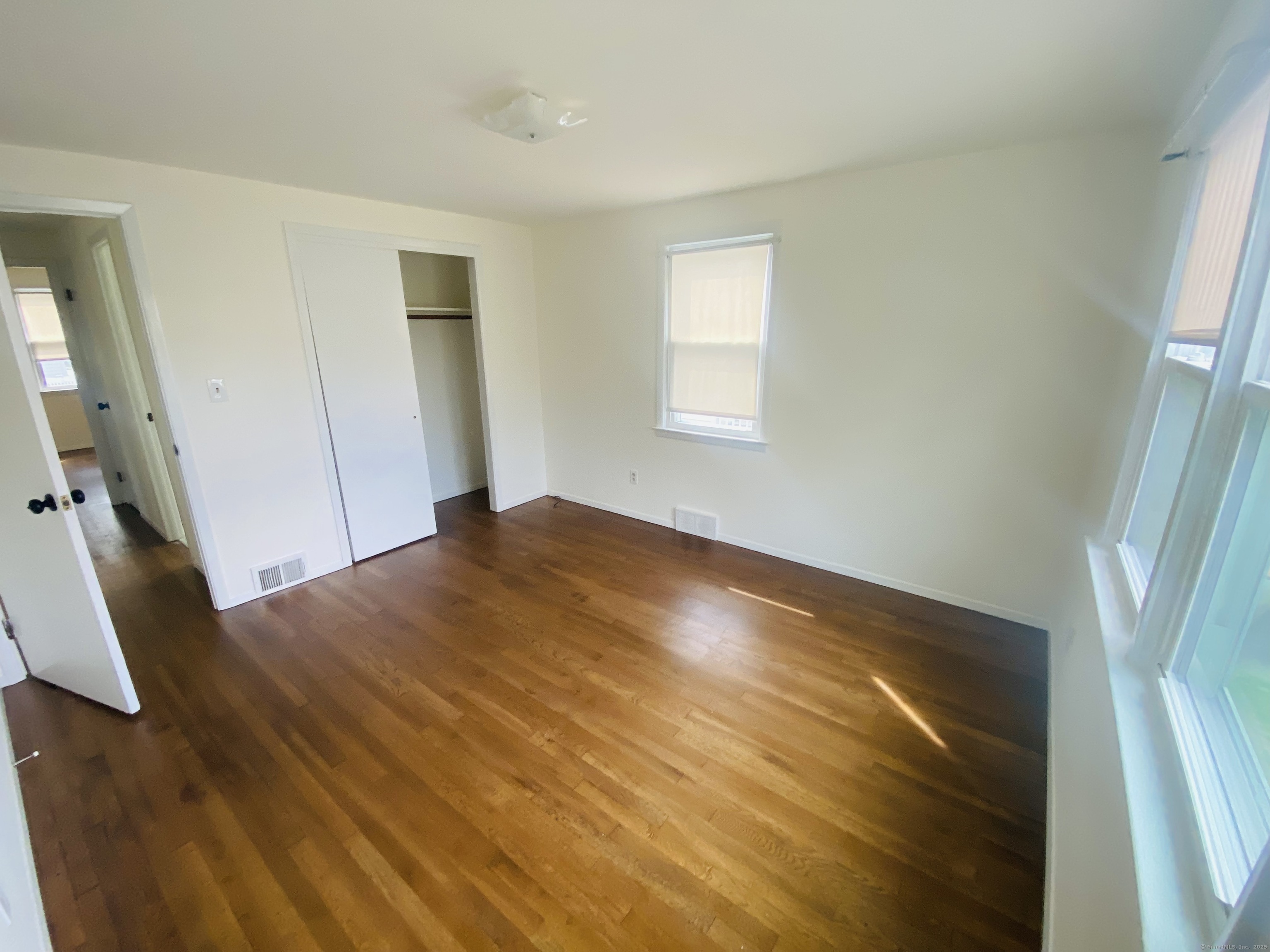35 Harding Avenue Stratford, CT 06615 - Photo 9 of 10 a view of empty room with wooden floor