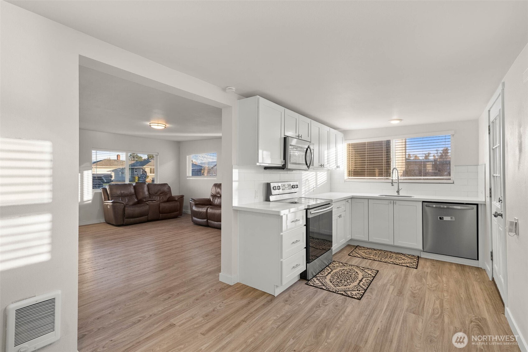 503 Coe Lane Southwest Orting, WA 98360 - Photo 12 of 26 a kitchen with a sink cabinets and wooden floor