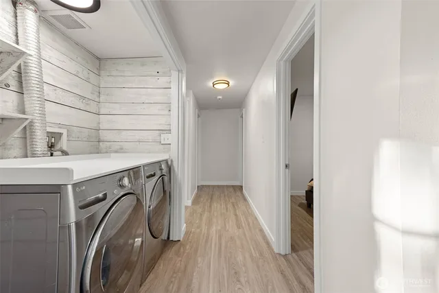 a view of a bathroom with a sink and wooden floor