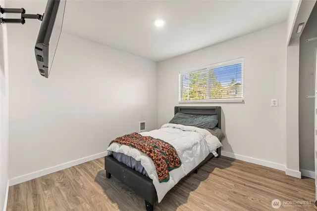 a bedroom with a bed and a window