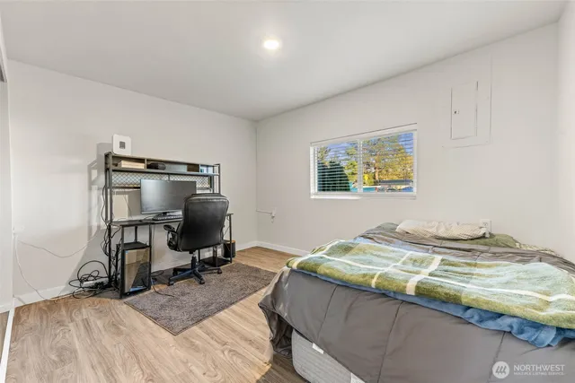 a bedroom with a bed and a desk