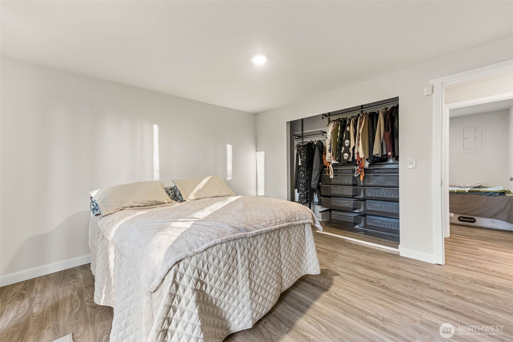 503 Coe Lane Southwest Orting, WA 98360 - Photo 20 of 26 a spacious bedroom with a bed and wooden floor