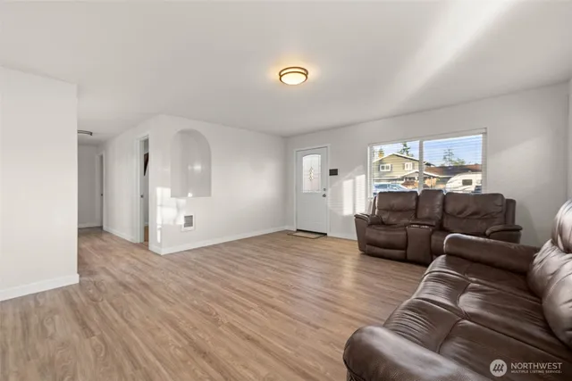 a living room with furniture and a chandelier