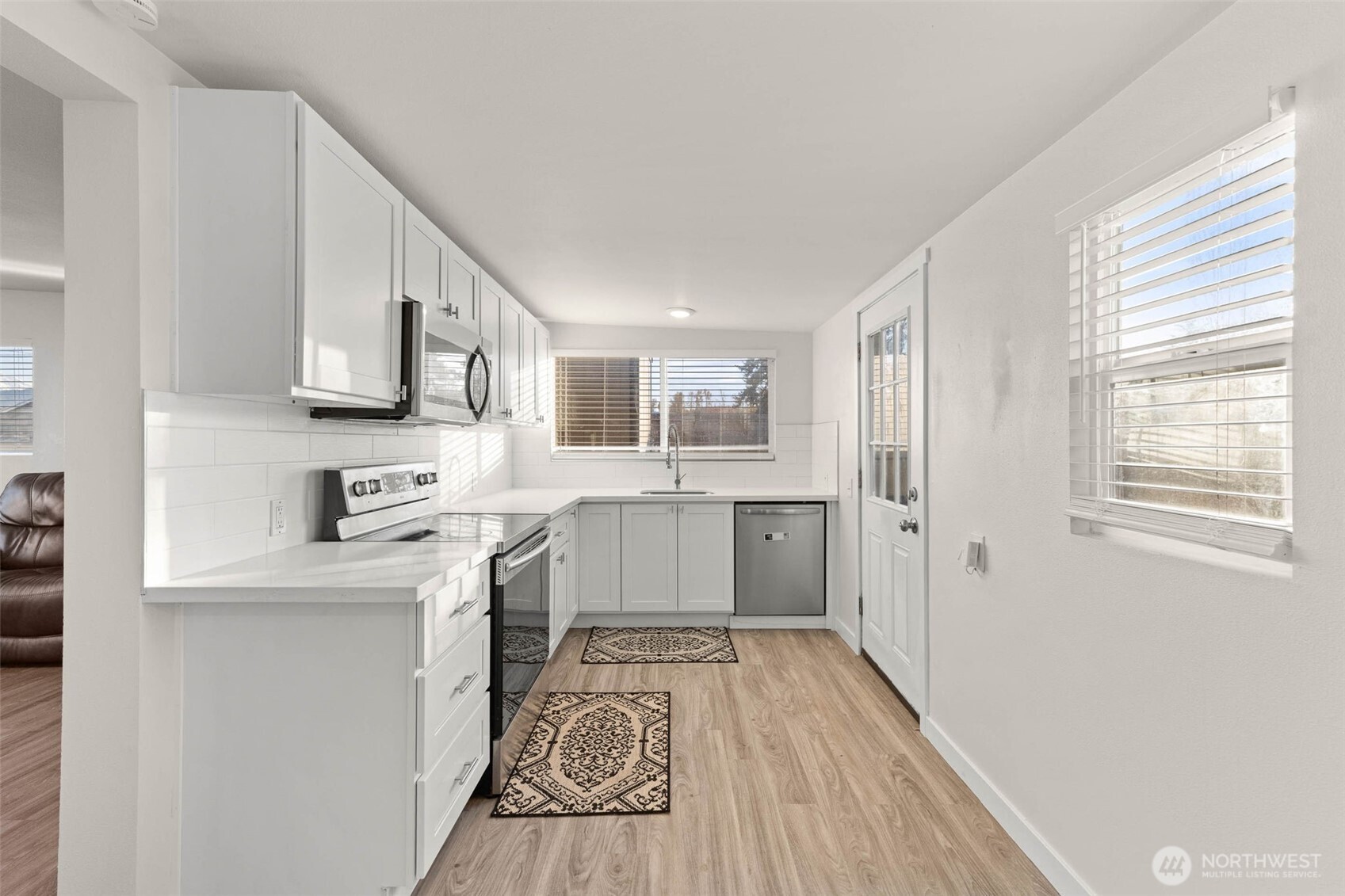 503 Coe Lane Southwest Orting, WA 98360 - Photo 9 of 26 a kitchen with stainless steel appliances granite countertop a refrigerator a sink dishwasher a stove with wooden cabinets and floor
