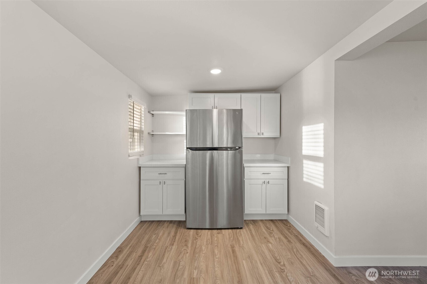 503 Coe Lane Southwest Orting, WA 98360 - Photo 10 of 26 a kitchen with a refrigerator a sink and dishwasher with wooden floor