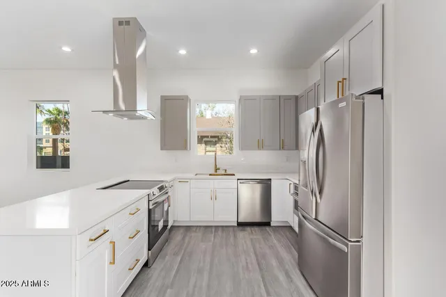 a kitchen with stainless steel appliances a refrigerator sink and microwave