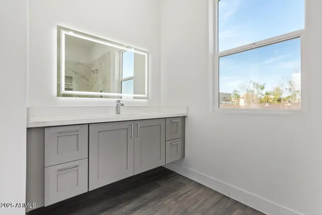 a bathroom with a sink mirror and vanity