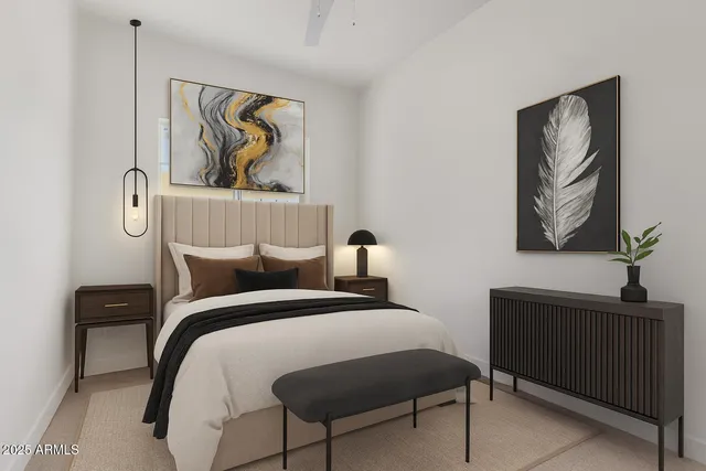 a bedroom with a bed and a painting on the wall