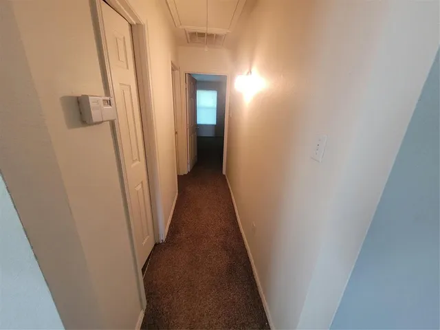 a view of a hallway with a wooden floor