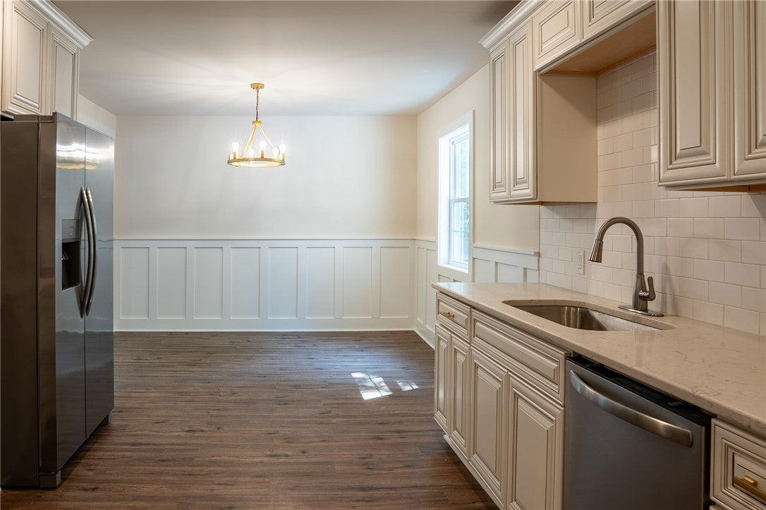 1312 Rocky Brook Road Opelika, AL 36801 - Photo 12 of 45 This spacious kitchen and dining area features elegant wainscoting and hardwood flooring.